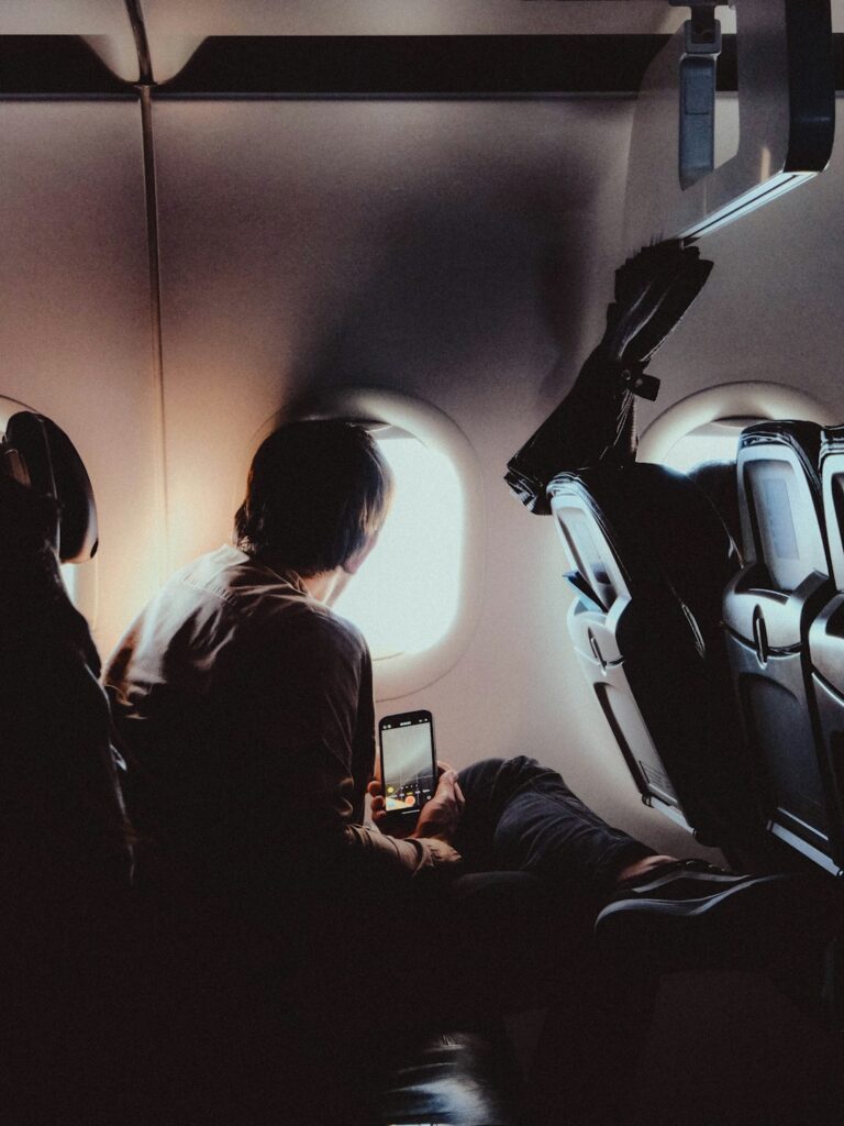 Passengers on an aeroplane looking out the window during a flight