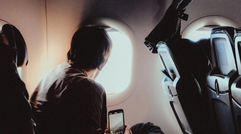 Passengers on an aeroplane looking out the window during a flight