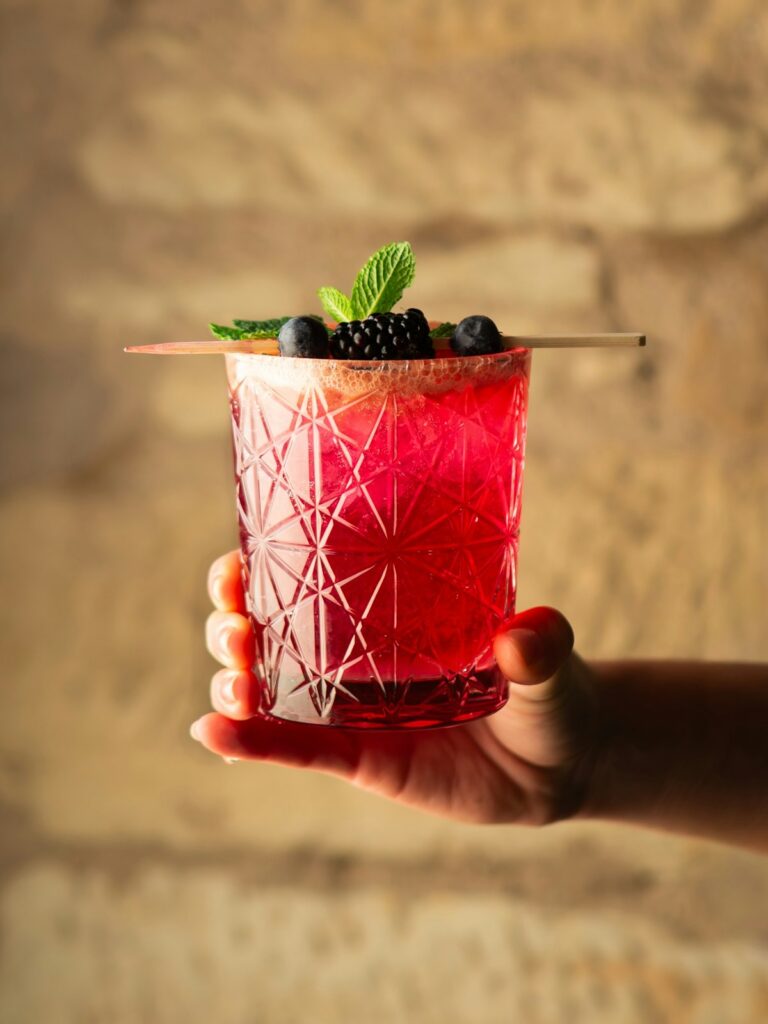 A vibrant berry cocktail garnished with fresh mint and blackberries representing the bold new food and drink trends at IFE 2026