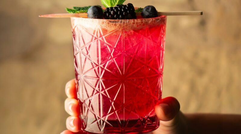 A vibrant berry cocktail garnished with fresh mint and blackberries representing the bold new food and drink trends at IFE 2026