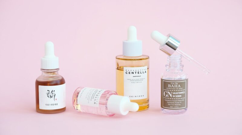 Korean skincare serums and bottles arranged on a pink background