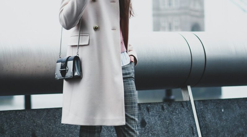 Woman in tailored coat near Tower Bridge, London