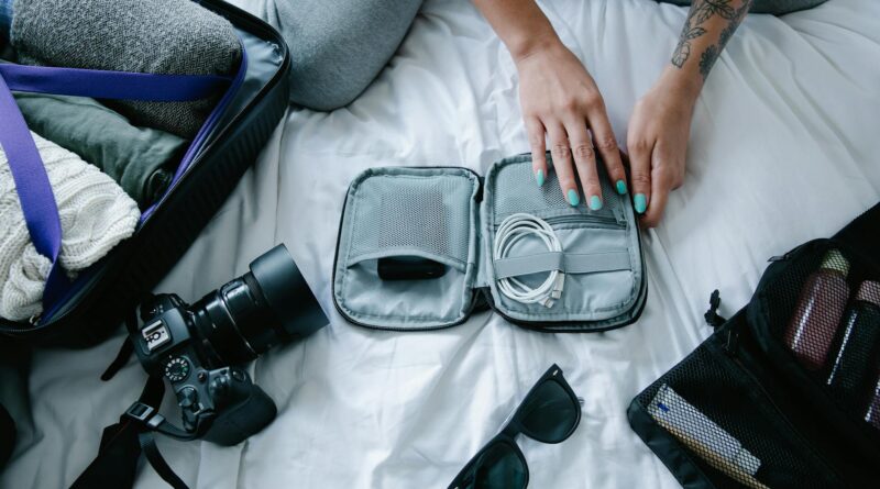 hands on gray bag with cable charger
