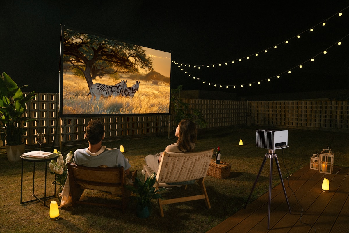 couple enjoying an outdoor movie night - best portable projector under £200 UK for outdoor use