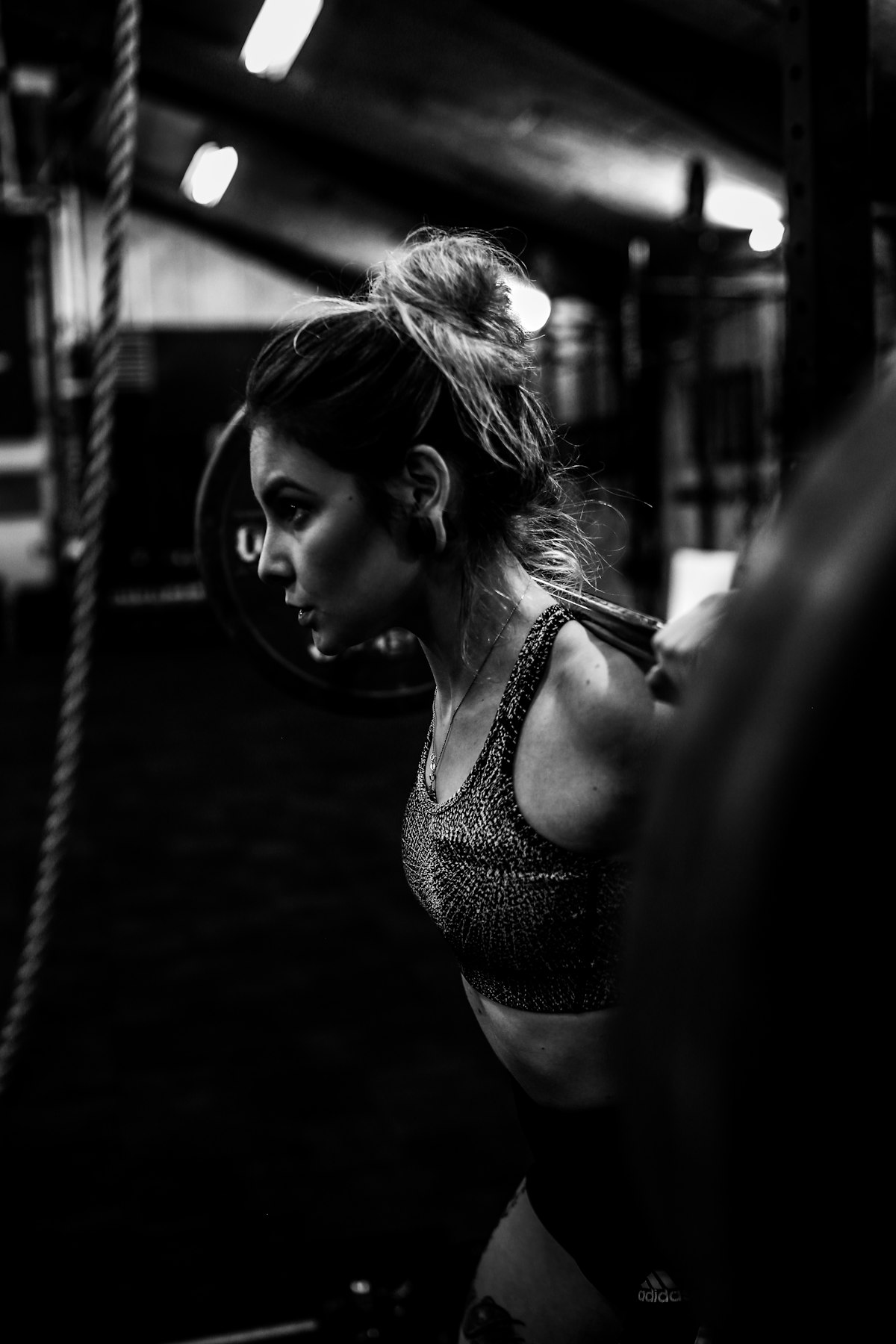 woman doing resistance training in gym - creatine benefits for women bone density