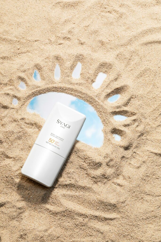 Best daily SPF face cream UK - sunscreen bottle on sand