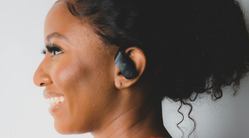 Runner wearing open ear headphones while jogging outdoors in the UK