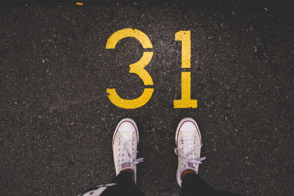 A pair of clean white trainers on tarmac, illustrating the best white trainers UK 2026 has to offer.