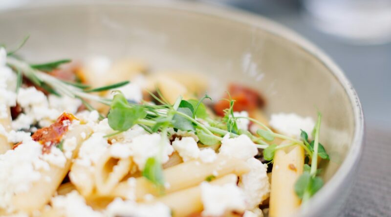 Foods for better skin UK: a supermarket-style spread of oily fish, leafy greens, berries, peppers and wholegrains on a wooden board.