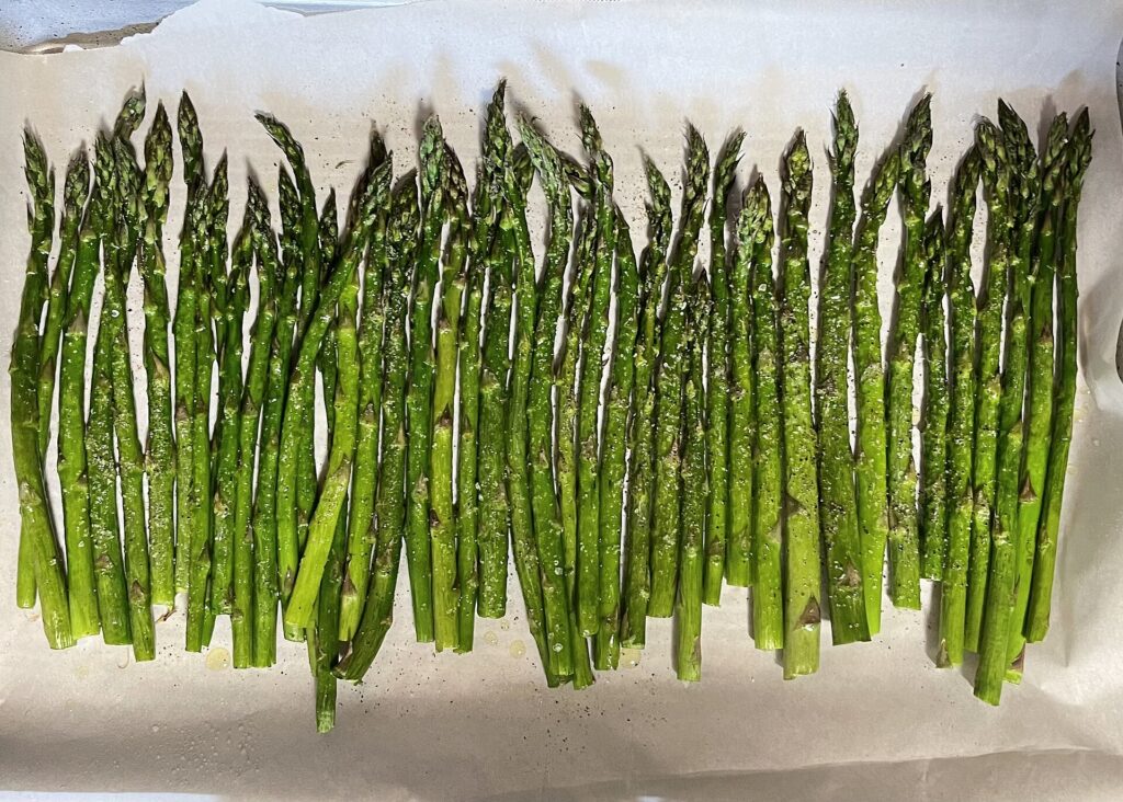 Roasted spears on a baking tray - one of the simplest British asparagus recipes for a spring weeknight.