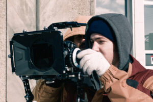 A documentary film crew working behind the scenes, illustrating the craft of non-fiction filmmaking.