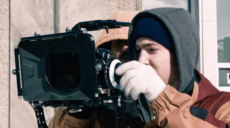 A documentary film crew working behind the scenes, illustrating the craft of non-fiction filmmaking.