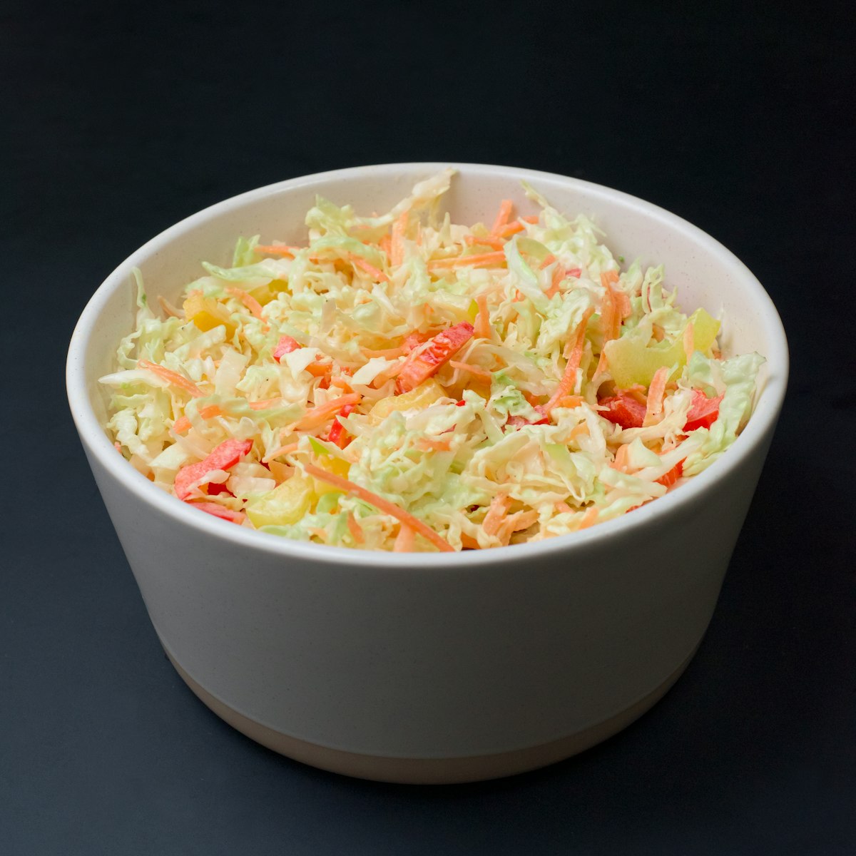 Easy cabbage coleslaw recipe in a white bowl