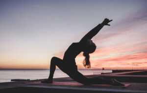 Woman practising yoga as part of cycle syncing workouts routine