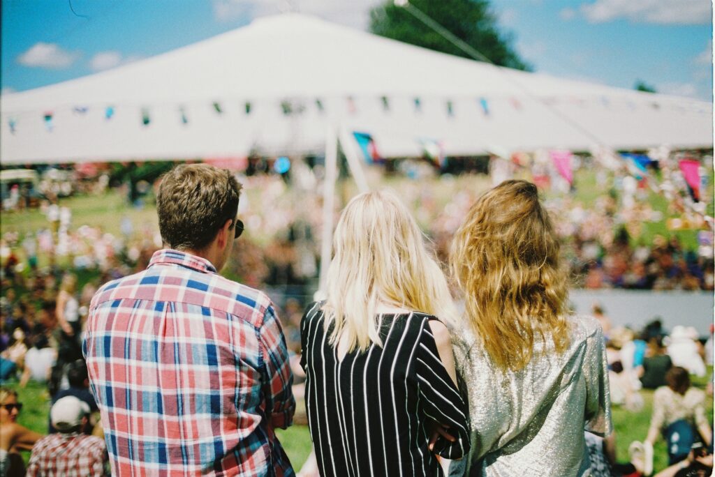 Young festival goers in summer festival outfits UK 2026 styling, captured at a British festival.