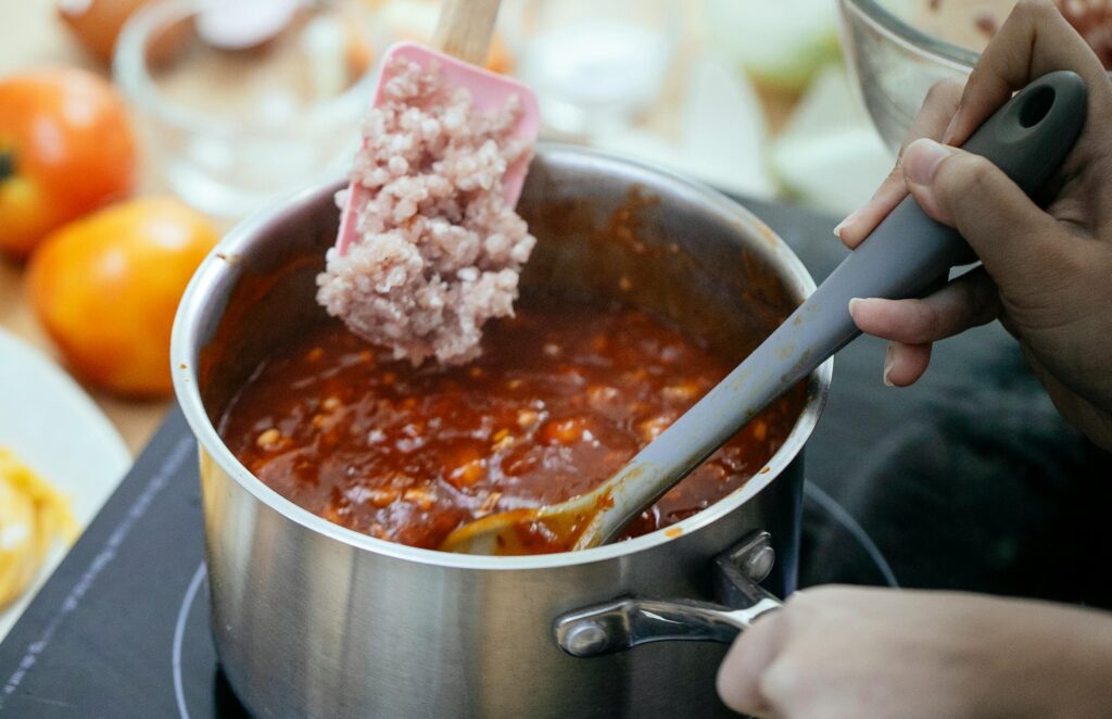 A cook adds British lamb mince into a hot pan, the kind of starting point most lamb mince recipes UK home cooks make on a weeknight.
