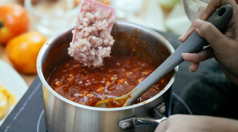 A cook adds British lamb mince into a hot pan, the kind of starting point most lamb mince recipes UK home cooks make on a weeknight.