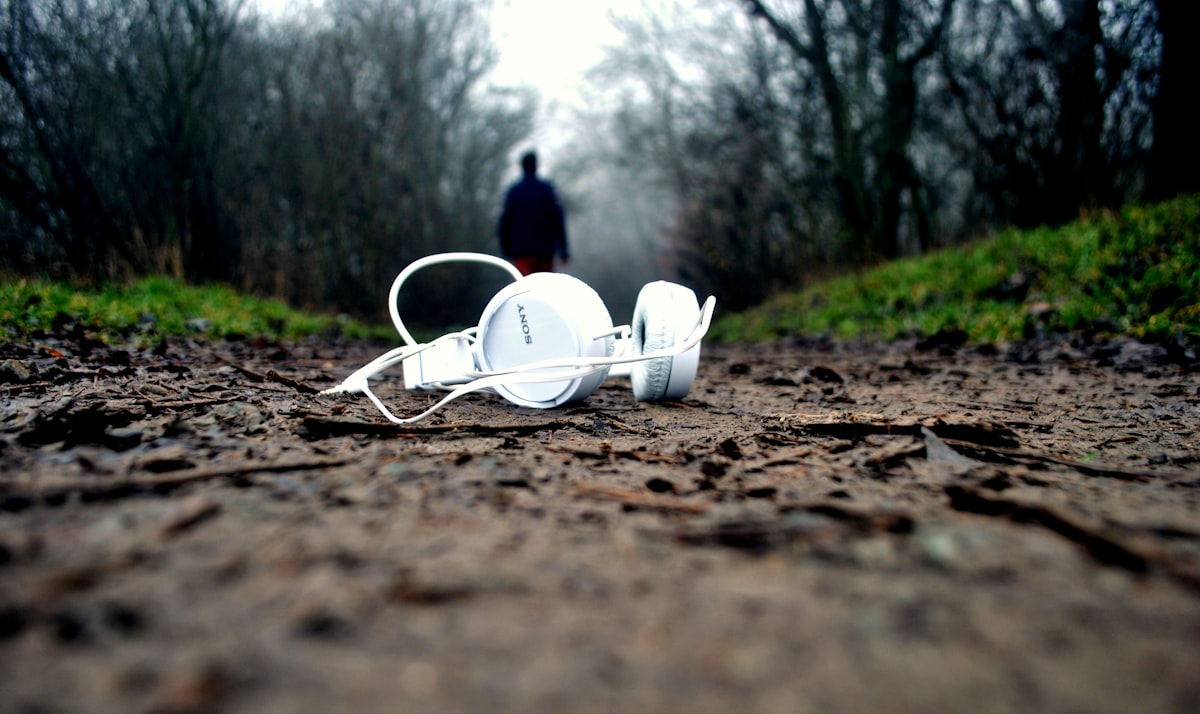Person running outdoors with open ear headphones UK 2026