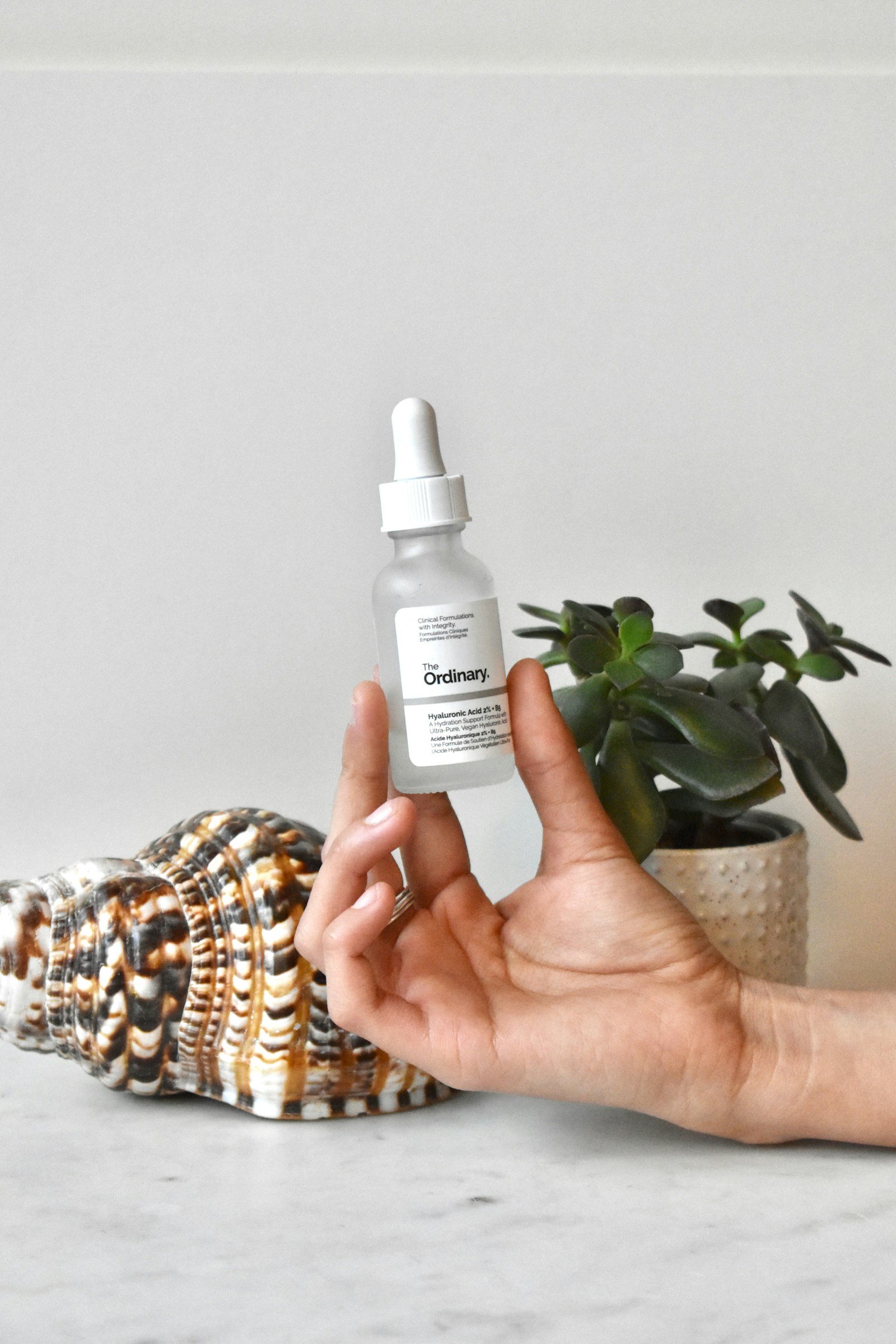 PDRN skincare UK routine with serum applied to hand