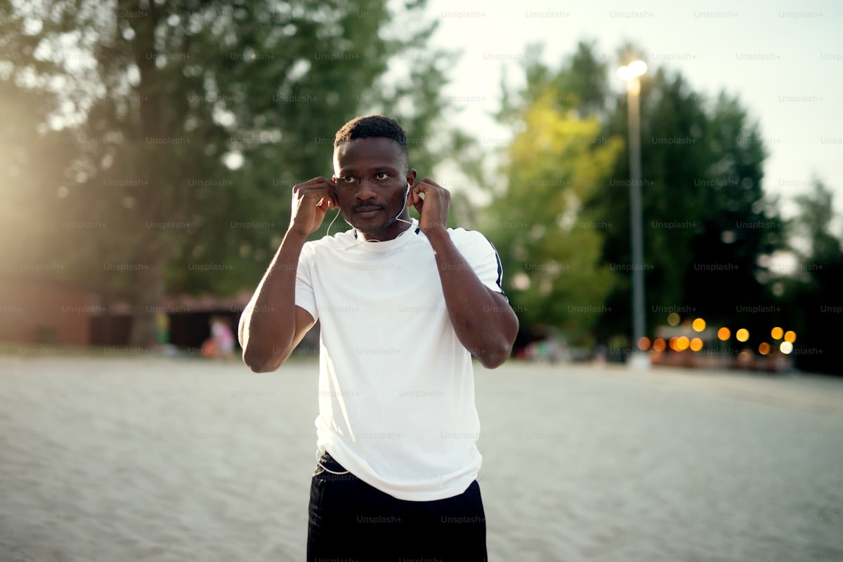 Person wearing noise cancelling earbuds while commuting outdoors in the UK