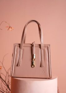 UK handbag trends 2026: blush-pink leather top-handle bag, spring editorial style