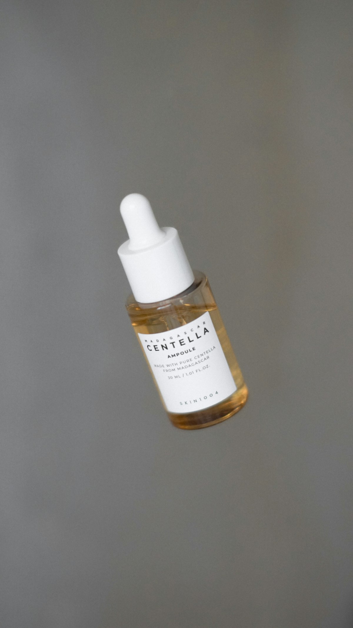 serum dropper bottle with drop of liquid - peptide serum skincare