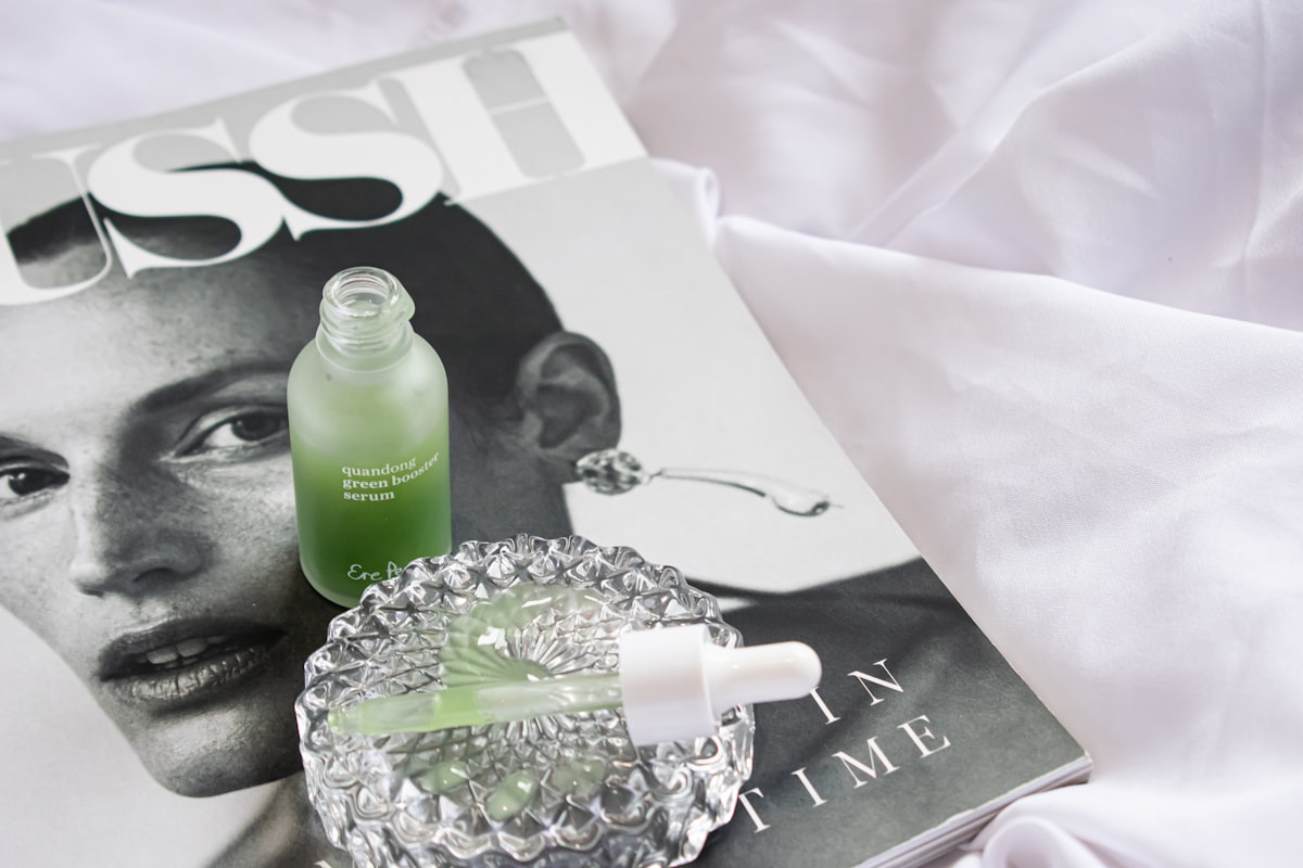 skincare serum bottle with beauty magazine flat lay - peptide serums UK