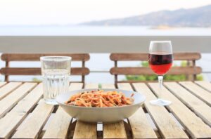 A plate of store cupboard dinners UK staples: pasta with tinned tomato sauce, capers and tuna.