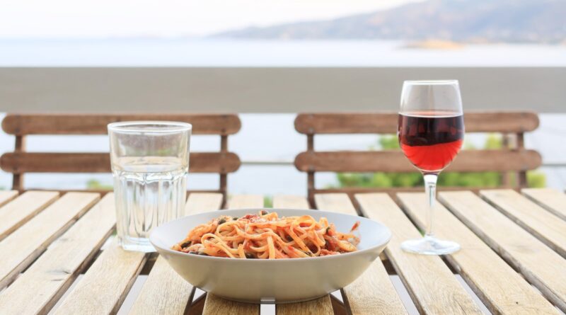 A plate of store cupboard dinners UK staples: pasta with tinned tomato sauce, capers and tuna.