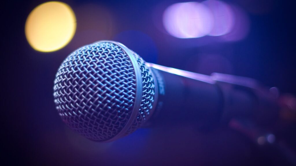 Studio microphone in coloured stage light, illustrating BBC Sounds audio drama production in the UK in 2026