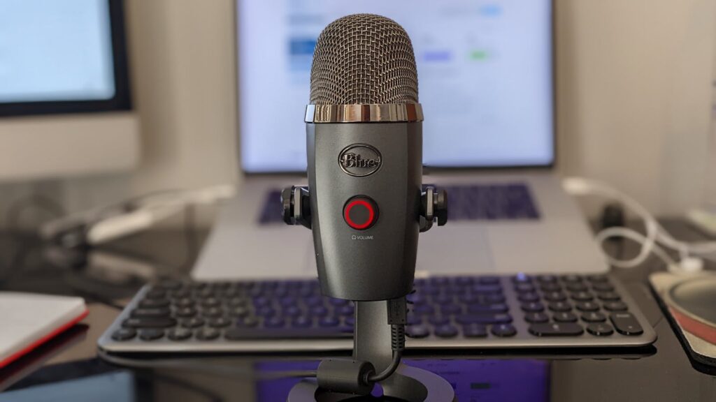 One of the best USB microphones UK home workers can buy under £150, set up on a desk in front of a laptop for video calls.