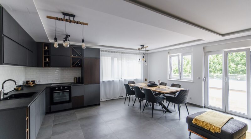 Modern UK kitchen and dining area illustrating broken-plan living with zoned cooking and eating spaces