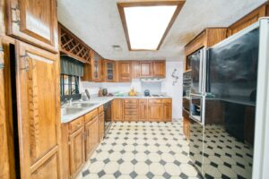 A galley kitchen with checkerboard floors in monochrome tile, the defining UK interiors trend of 2026.