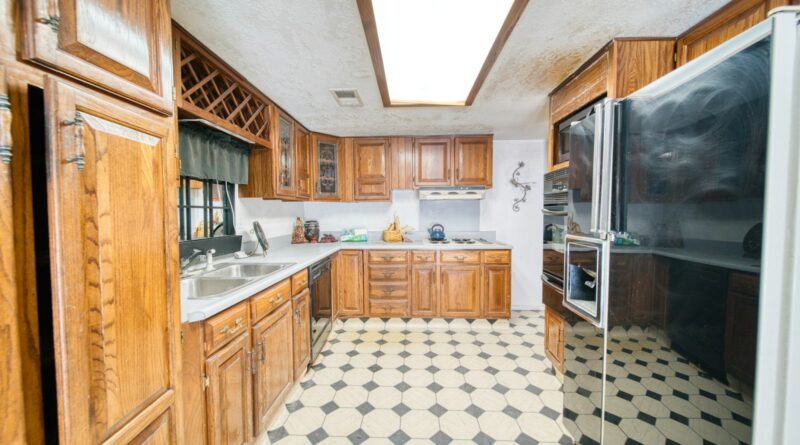 A galley kitchen with checkerboard floors in monochrome tile, the defining UK interiors trend of 2026.