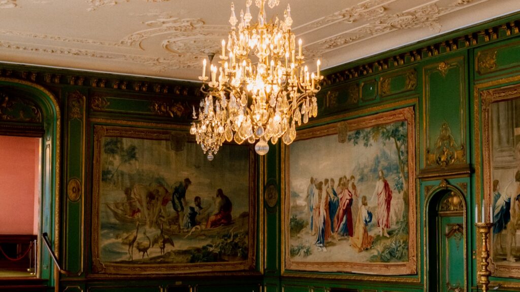 A deep green colour drenched room with painted walls, ceiling cornice and woodwork in matching emerald - the colour drenching UK 2026 trend