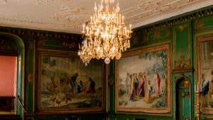 A deep green colour drenched room with painted walls, ceiling cornice and woodwork in matching emerald - the colour drenching UK 2026 trend