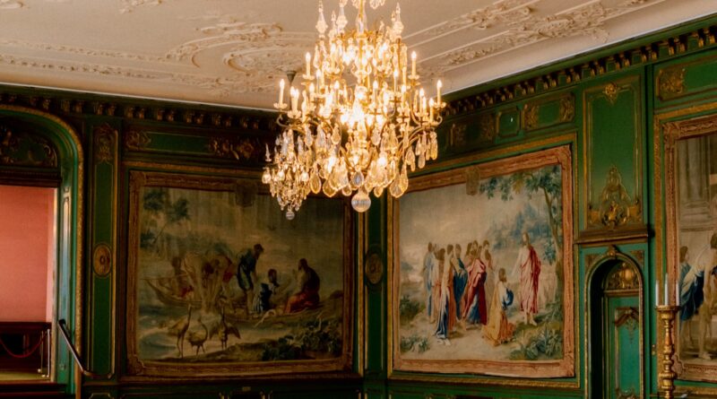 A deep green colour drenched room with painted walls, ceiling cornice and woodwork in matching emerald - the colour drenching UK 2026 trend