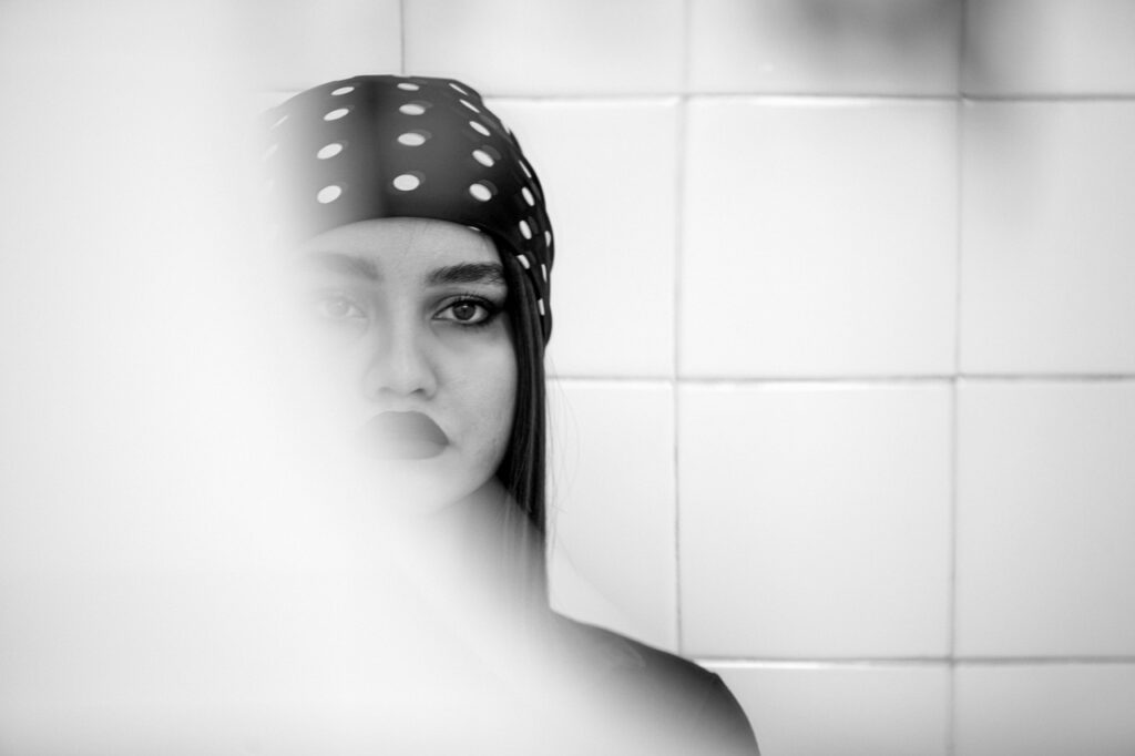 British woman looking at her face in the bathroom mirror, illustrating the cortisol face UK trend