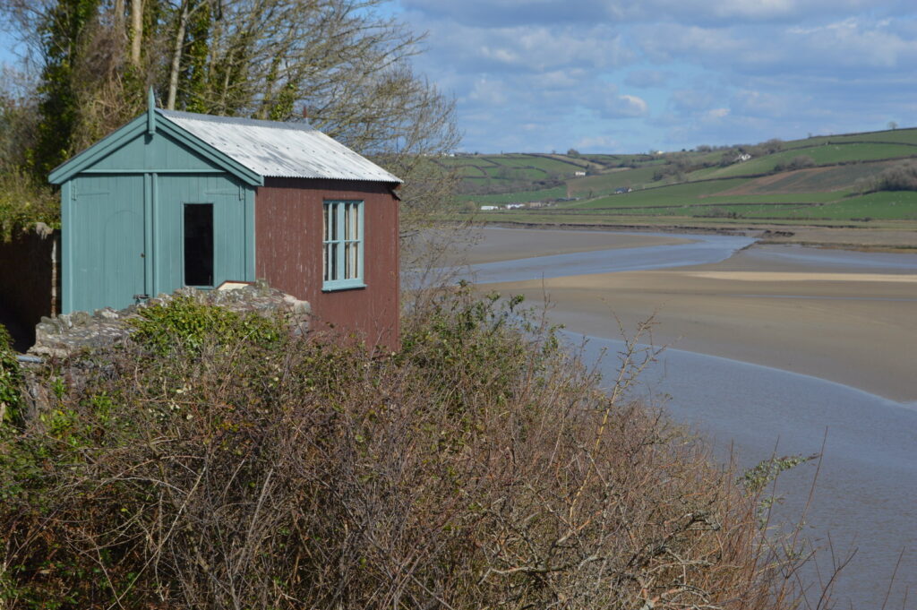 Dylan Thomas writing shed overlooking a Welsh estuary, an iconic example of a garden office UK writers and home workers continue to find inspirational.