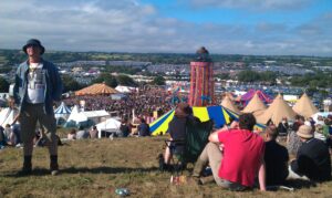 Festival tech essentials UK 2026 in action: crowd gathers at a UK summer music festival with phones and portable gear visible.