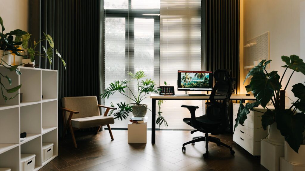 Bright UK home office with low-maintenance home office plants on a desk by a window