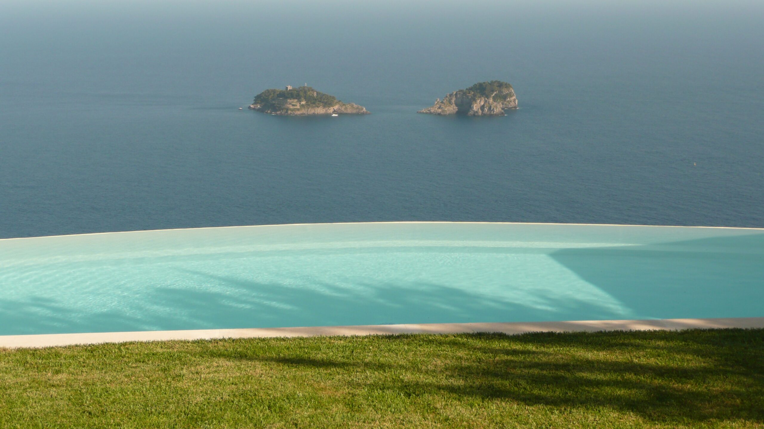 A Mediterranean villa pool at dusk, the kind of setting that will host Love Island 2026 from 1 June