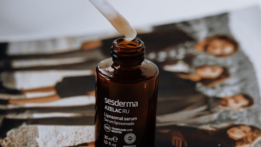 Editorial flat lay of a skincare serum bottle representing madecassoside UK skincare for reactive skin