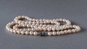 A long baroque-pearl necklace with sterling silver clasp - representative of pearl jewellery 2026 trends in UK summer styling.