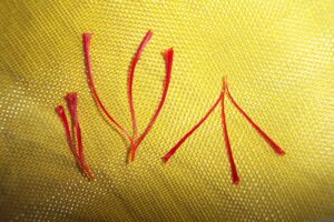 Saffron threads on yellow fabric, illustrating saffron supplements UK 2026 and their use for mood and PMS