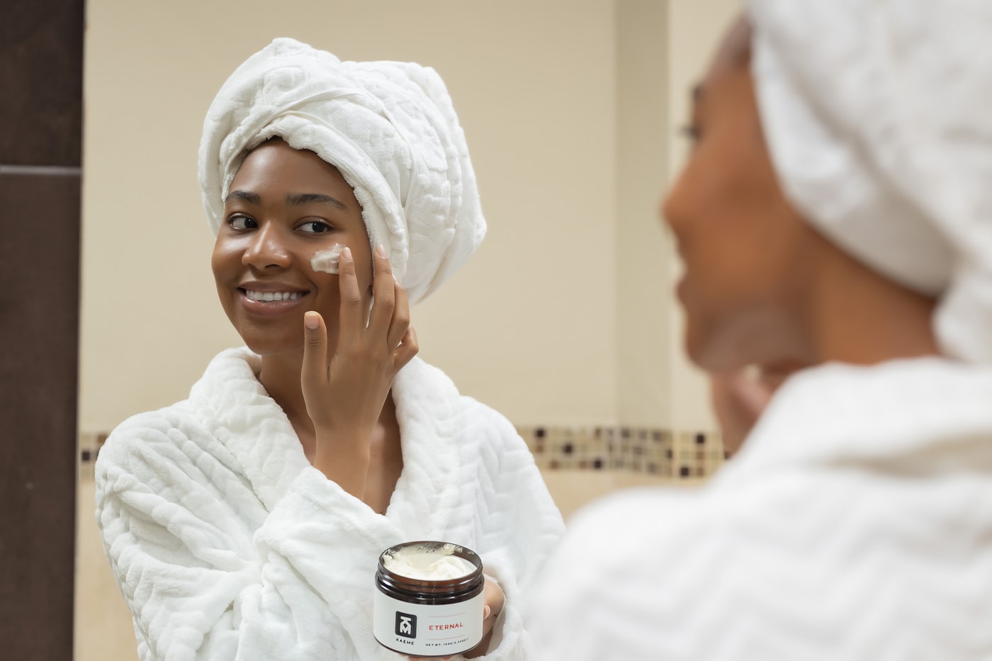 Woman applying night cream as part of a slugging skincare UK routine
