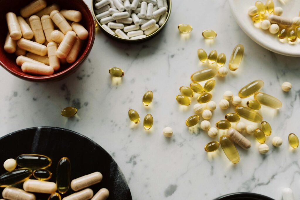 Flat lay of spermidine supplements UK shoppers can buy in 2026, capsules and tablets on a neutral surface