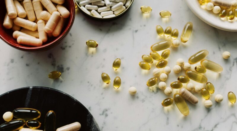 Flat lay of spermidine supplements UK shoppers can buy in 2026, capsules and tablets on a neutral surface