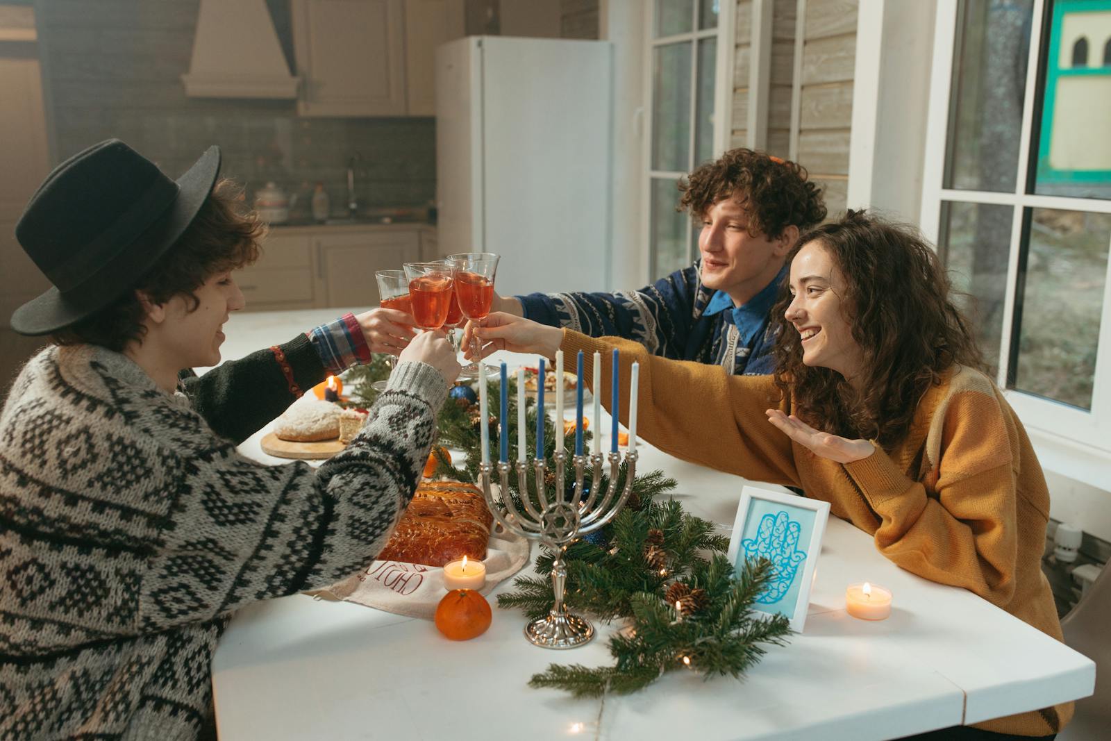 A group of friends sitting around a candlelit table at night, capturing the ensemble dynamic central to the Two Weeks in August review