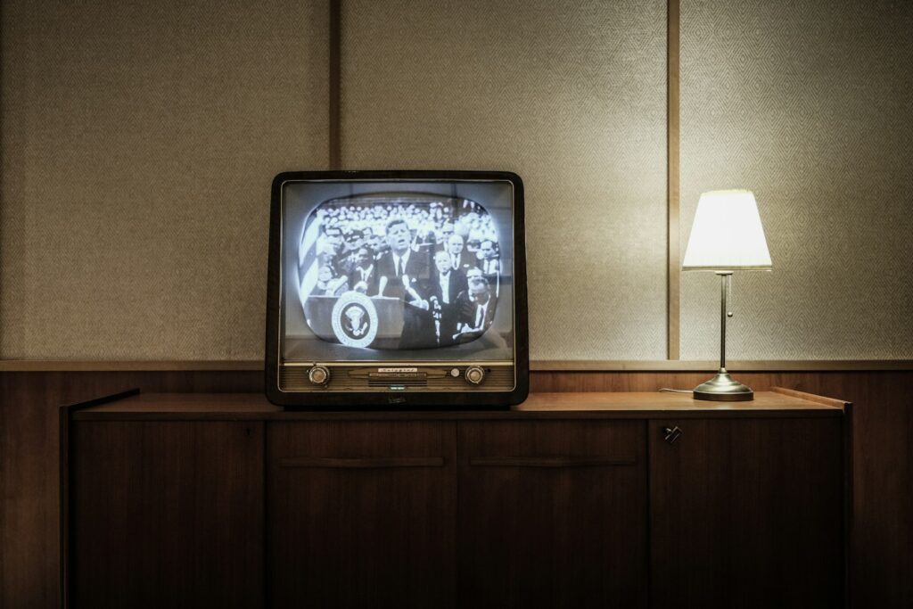Vintage CRT television set in a softly lit living room, evoking the era when UK soap operas became national fixtures.